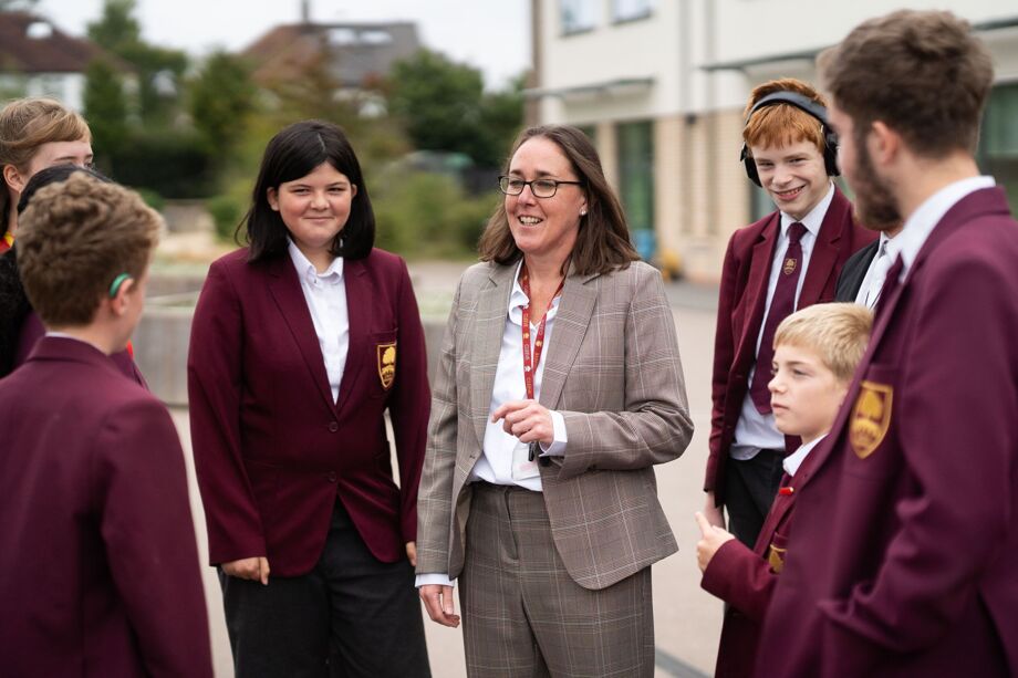 Head of School talking on playground to students